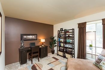 a home office with a desk and a bookshelf  at Bay Pointe Apartments, Lafayette